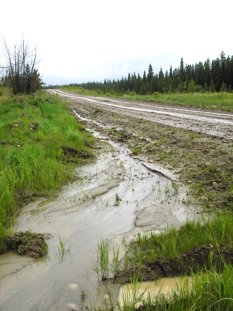 water running by a dirt road