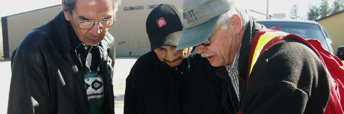 men looking at a harvest plan