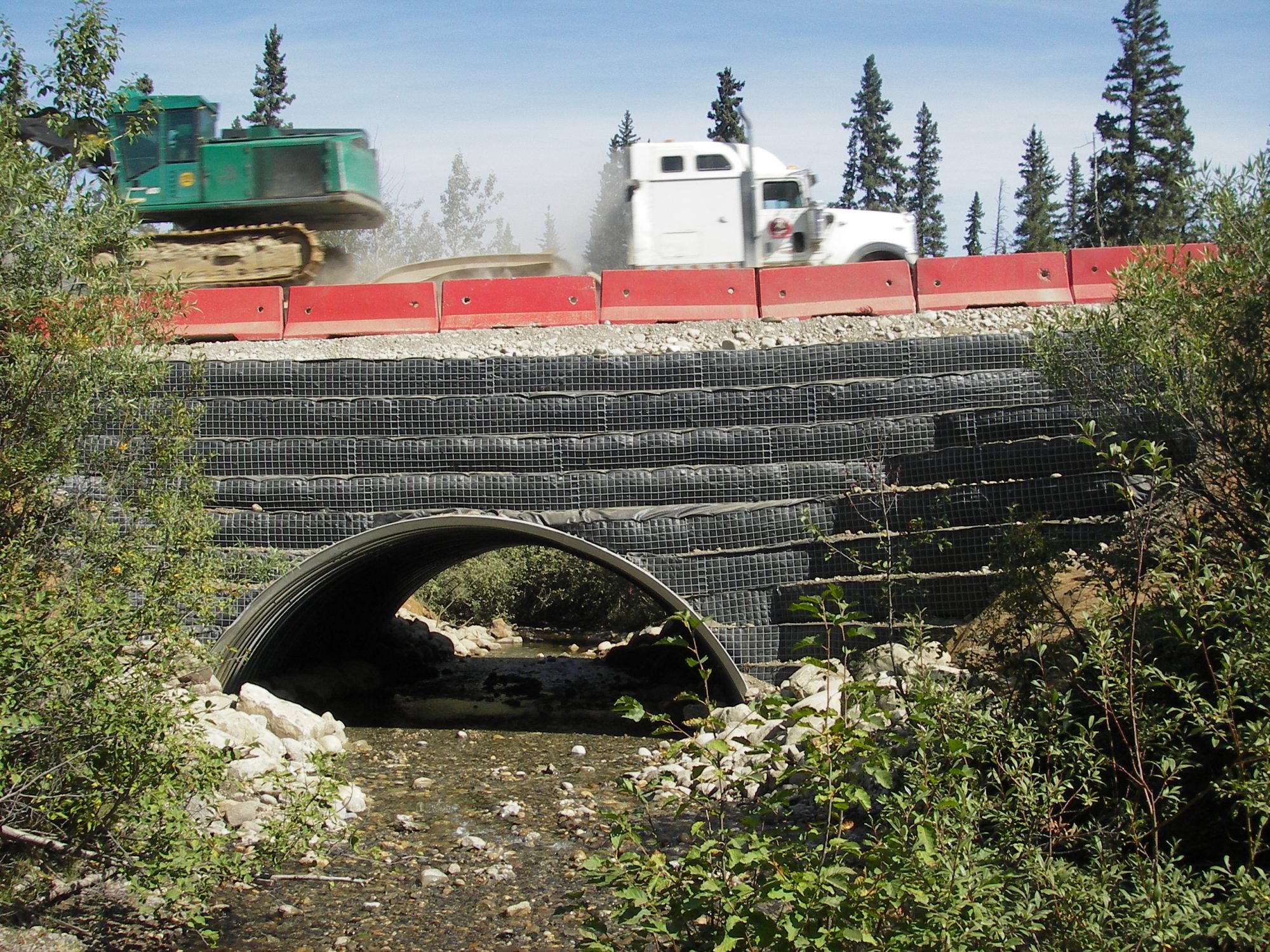 truck crossing a creek bridge